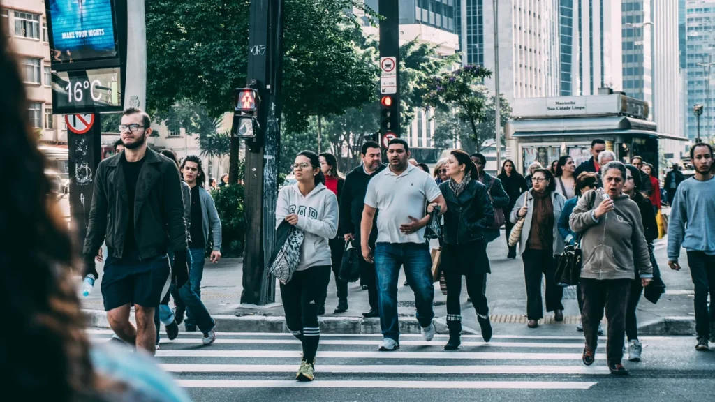 Group of citizens crossing a busy city street, symbolizing community and public life