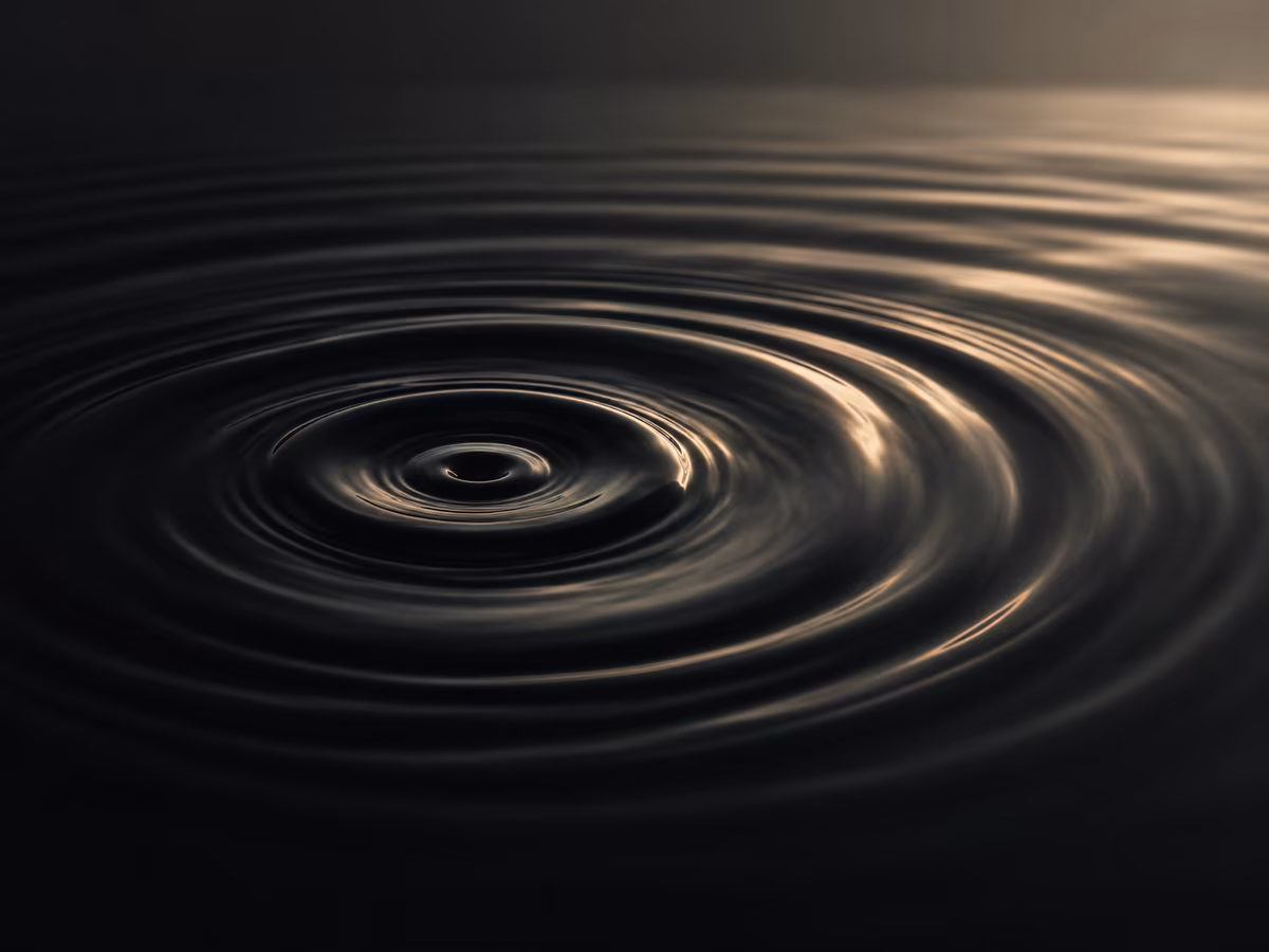 Concentric ripples spreading across dark water, symbolizing hidden cultural patterns.